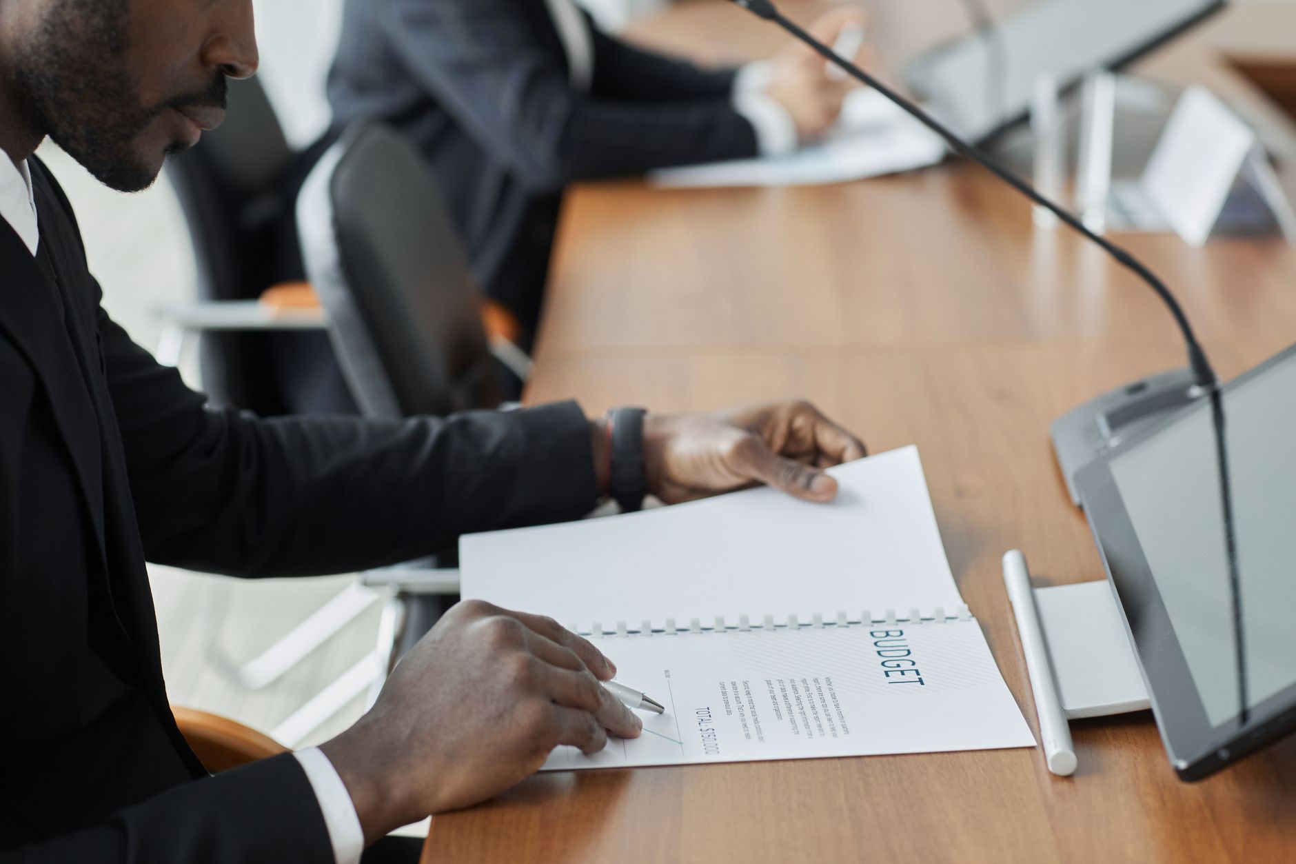 Corporate meeting room reviewing strategic bid proposals
